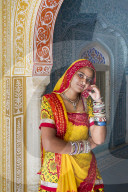 India, Rajasthan, Jaipur, Samode Palace, lady wearing a colourful Sari in ornate passageway - Model and Property released