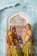 India, Rajasthan, Jaipur, Samode Palace, ladies wearing a colourful Sari in ornate passageway - Model and Property released