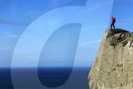 A hiker looks out to sea from cliffs at Fair Head, Northern Ireland