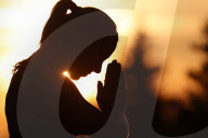 Silhouette of a woman practicing yoga against the light of the evening sun. French Alps. France.