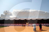 Chua Thien Lam pagoda. Reclining Buddha. Worshippers praying the Buddha.