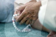 Masjid Al Rahim Mosque. Man praying in a mosque with Tasbih (prayer beads), Close-up. Ho Chi Minh City. Vietnam.