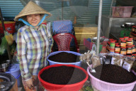 Morning market in Duong Dong town. Woman selling black peppercorns. Phu Quoc. Vietnam.