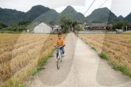 Rural life. Boy ridding bicycle. Bac Son. Vietnam.