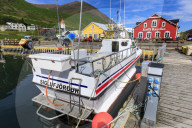 Church, busy cafes, fishing boat and mountains, Siglufjordur, (Siglufjorour), stunning Summer weather, North Iceland, Europe