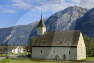 Old white church 1309, sunny day, mountain and village backdrop, Eidfjord, Norwegian Western Fjords, Norway, Europe
