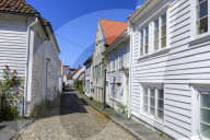 Beautiful old town, cobbled street, flowers and white wooden houses, blue sky, Summer, Gamle Stavanger, Rogaland, Norway, Europe
