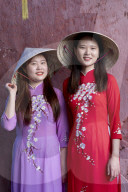Young Vietnamese women wearing a traditional Ao Dai dress‚Äô;