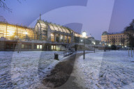 Palmenhaus greenhouse view from the Hofburg palace gardens covered with snow, Burggarten, Vienna, Austria