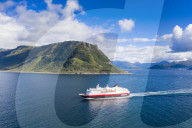 Aerial view of Hurtigruten during a daily trip along the fjord, Alesund, More og Romsdal county, Norway (drone)
