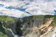 Hikers admiring Voringsfossen waterfall from the above canyon, Eidfjord, Hordaland county, Norway