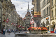 Tourists along Marktgasse, shopping street in the Old Town (Altstadt) with Kafigturm tower in background, Bern, Switzerland