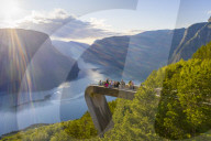 Tourists admiring the fjord from Stegastein viewpoint, Aurlandsvangen, Sognefjord, Norway