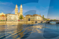 Ferry along Limmat River next to Munsterbrucke bridge with Grossmunster in background, Zurich, Switzerland