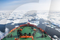 People enjoying the breaking ice on board of an icebreaker, North Pole, Arctic