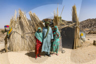 Tuareg family posing in fron of their hut, near Tamanrasset, Algeria