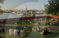 Young people picnic at sunset in the Summer in the fashionable SÃ¶dermalm neighbourhood and district of Stockholm; Sweden