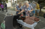 Tourists buy traditional churchkhela for sale at the market place in the town of Signagi,Georgia