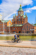 View of Uspenski cathedral and harbor with cyclists in the foreground, Helsinki, Uusimaa, Finland, Scandinavia, Europe