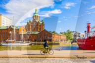 View of Uspenski cathedral and harbor with a cyclist in the foreground, Helsinki, Uusimaa, Finland, Scandinavia, Europe