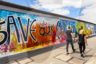 People walking in front of the Berlin Wall, Berlin, Germany, Europe