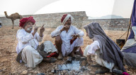 Camel herders early in the morning at the Pushkar Camel fair, Pushkar, Rajasthan, India, Asia,