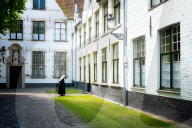 Nun at Begijnhof (Beguinage), Order of St. Benedict convent, Bruges, Belgium, Europe