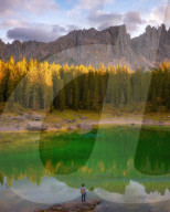 Young man observing the beauty of Lago Di Carezza at sunset, Dolomites, Italy, Europe