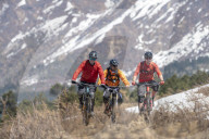 Mountain biking in the Himalayas with views of the Langtang mountain range in the distance