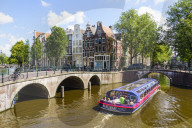 Tourist boat crossing Keisersgracht canal, Amsterdam, Netherlands