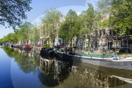 Old gabled buildings reflecting in a canal, Amsterdam, Netherlands
