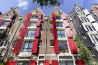 Red shutters on traditional dutch style building, Amsterdam, Netherlands