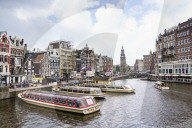 Tourist boats on Amstel River near Muntplein and Rokin, Amsterdam, Netherlands