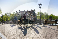 Cyclists on a bridge over Brouwersgracht, Amsterdam, Netherlands