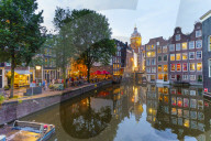 Restaurants by a canal at dusk, Oudezijds Kolk, Amsterdam, Netherlands