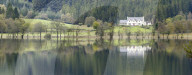 White house overlooking Loch Chon, The Lomond and Trossachs National Park, Sterlingshire, Scotland.