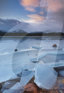 Ice sheets in severe winter weather on Loch Morlich, at daybreak.