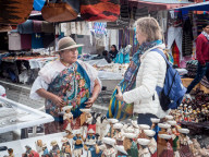 Tourist shopping at market, Plaza de los Ponchos, Otavalo, Ecuador, South America