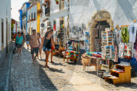 Tourists and shops in the typical alleys of the ancient fortified village of Obidos, Oeste Leiria District, Portugal, Europe
