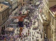 Man highlining with City Hall and Krakowskie Przedmiescie Promenade in the background, Urban Highline Festival, Lublin, Poland