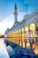 Abu Dhabi's magnificent Grand Mosque lit up during the evening blue hour.