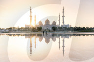 Abu Dhabi's magnificent Grand Mosque viewed in a reflecting pool.