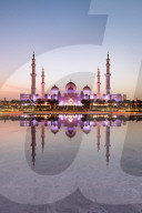 Abu Dhabi's magnificent Grand Mosque viewed in a reflecting pool.