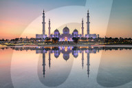 Abu Dhabi's magnificent Grand Mosque viewed in a reflecting pool.