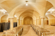Wine cellar with wooden barrels. Buglio in Monte, Valtellina, Lombardy, Italy, Europe.