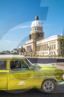 A green American car outside El Capitolio in Havana, La Habana, Cuba, West Indies, Caribbean, Central America