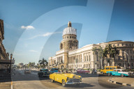 A yellow American classic car outside El Capitolio in Havana, La Habana, Cuba, West Indies, Caribbean, Central America