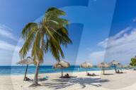 palm trees and umbrellas on the beach Playa Ancon near Trinidad, Trinidad, Cuba, West Indies, Caribbean, Central America