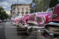 Colourful old American taxi cars parked in Havana at dusk, UNESCO, La Habana, Cuba, West Indies, Caribbean
