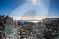Tourists walking down from top of El Teide volcano to Teide Cable Car in early moning. Tenerife, Canary Islands, Spain, Europe